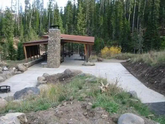 Hyalite Pavilion β Hyalite Pavilion, fireplace, picnic tables, fire ring & pine trees