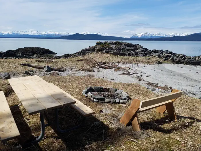 Berners Bay Cabin β Picnic table and fire ring on sand beach