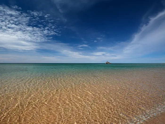 South Manitou Group Campground — View of the beach and Morazan Shipwreck in the distance under a blue sky from South Manitou Island