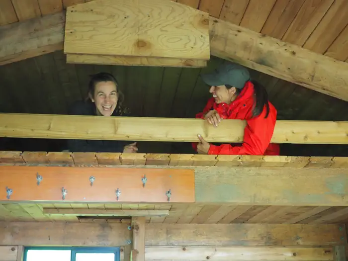 Frosty Bay Cabin — Two people in the cabin loft laughing