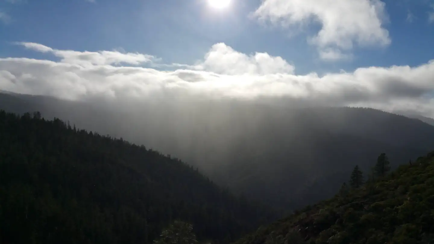 Post Creek Guard Station — View of mountains, clouds, sun.