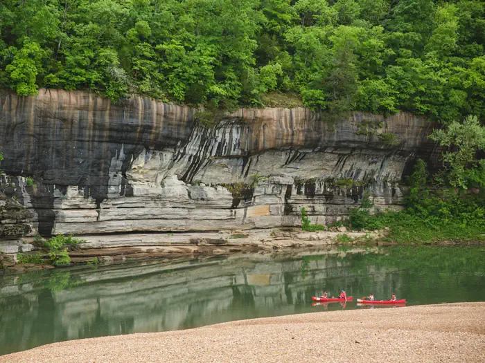 Buffalo Point — Painted Bluff at Buffalo Point with two red canoes in river.