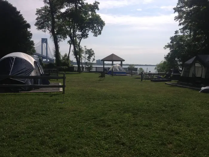 Camp Gateway - Staten Island — View of the campground with bridge in background- campsites have full sun