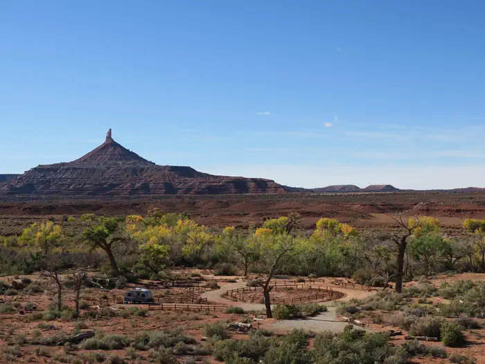 Superbowl Campground — Panoramic view of the desert campground with a ribbon of cottonwood trees and Six Shooter Peak in the background.