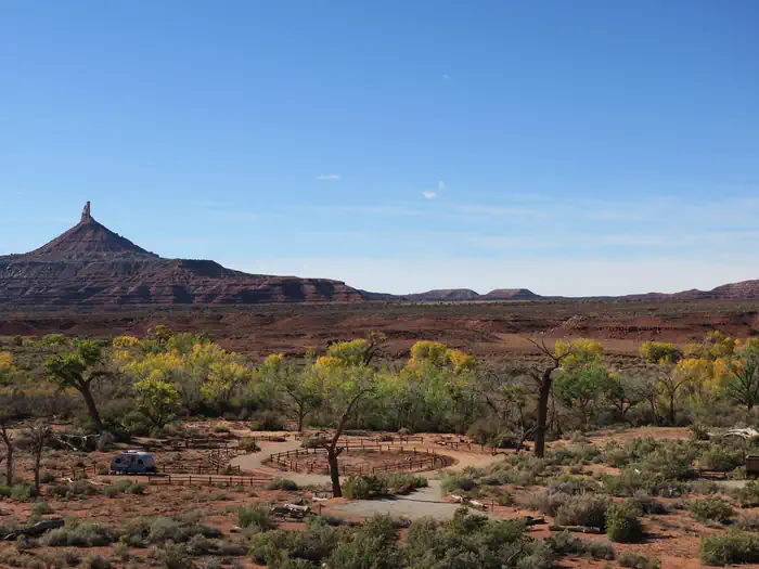 Superbowl Campground — Panoramic view of the desert campground with a ribbon of cottonwood trees and Six Shooter Peak in the background.