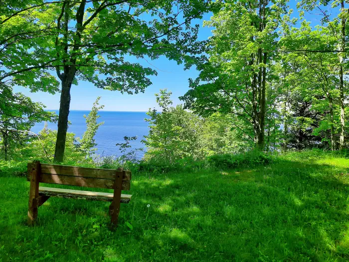 Black River Harbor Campground — Scenic view of Lake Superior from a bench in the campground.