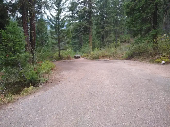 Bad Bear — A paved parking area with two concrete beams.