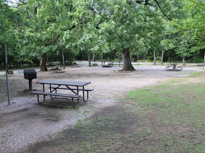 Rock Creek Campground - Chickasaw National Rec Area — A picnic table and grill at the the Rock Creek Campground group site