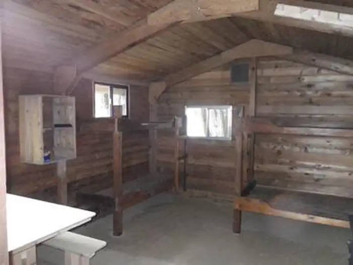 Harding River Cabin β Harding River Cabin wood interior with wood bunkbeds and table