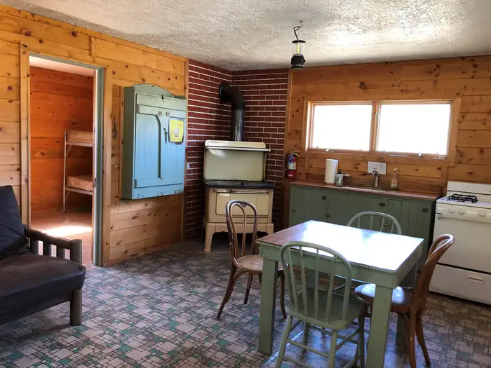 Podunk Guard Station — Woodstove, table and chairs, gas range and sink