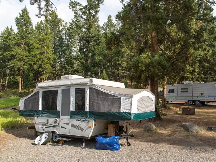 Tower Fall Campground — A popup camper in the woods at Tower Fall Campground