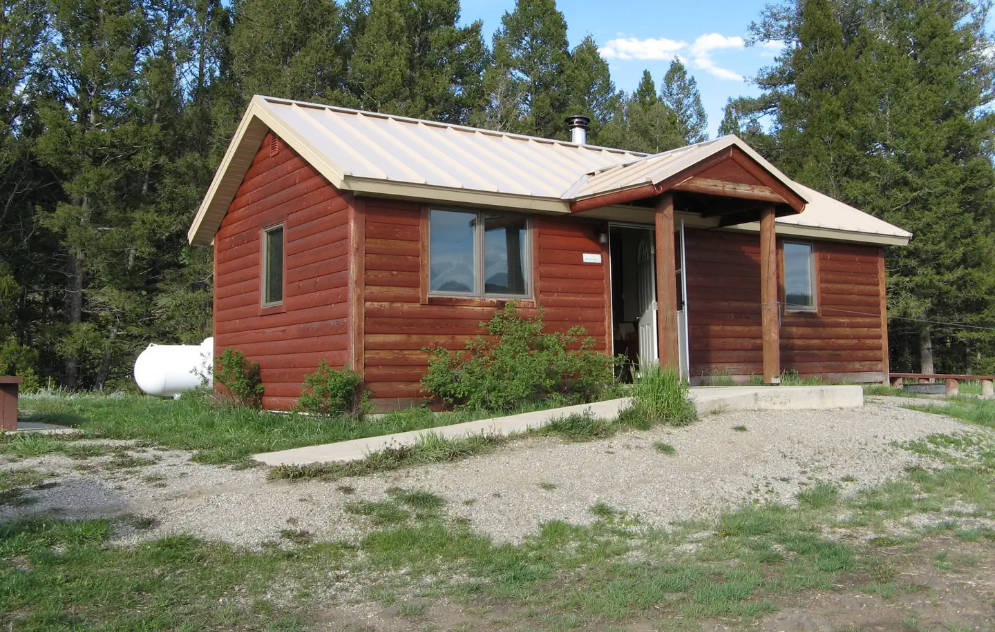Calf Creek Cabin — A red wooden cabin with two wings