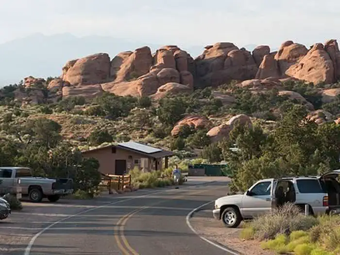 Devils Garden Campground — Campground road lined with campsites and boulders in the background.