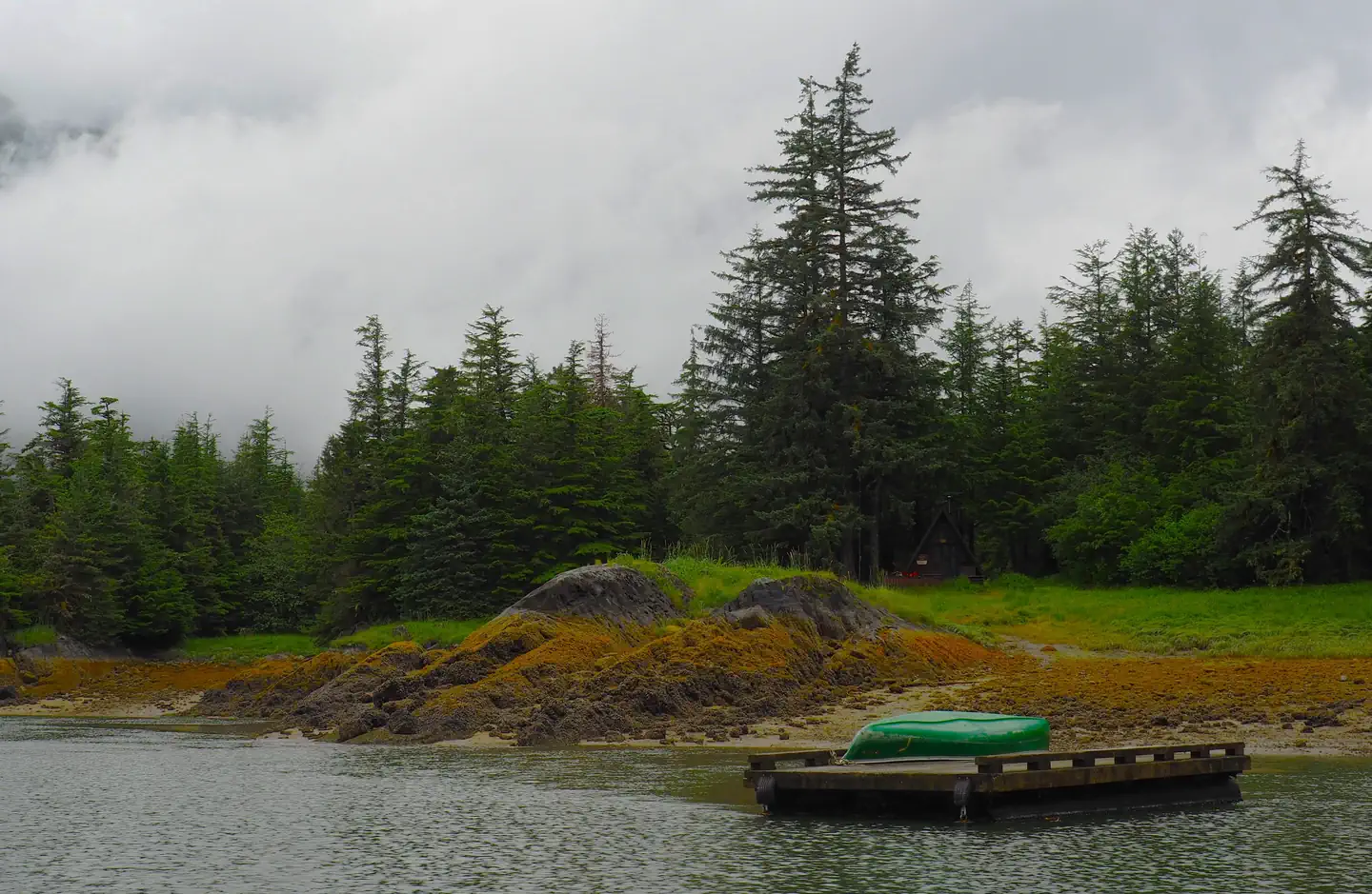 Berg Bay Cabin β Berg Bay with a canoe on a float with cabin in the background and trees