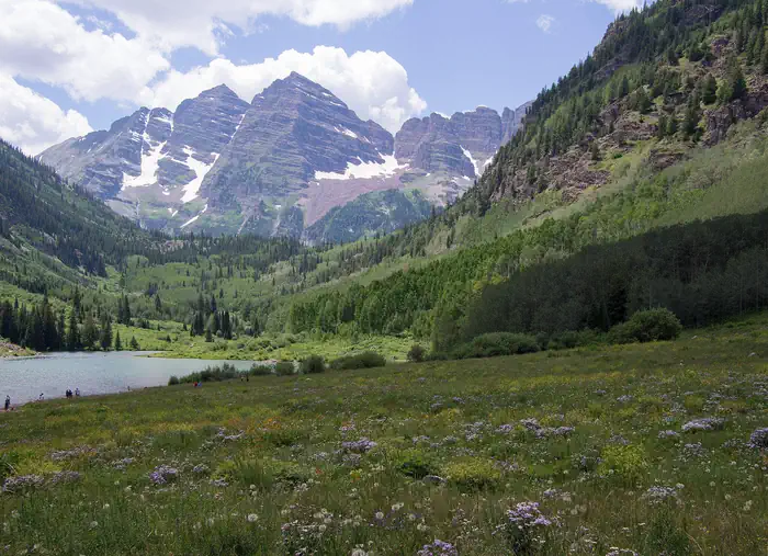 East Maroon Portal Picnic Site — The purple Maroon Bells peaks over Maroon Lake with wildflowers in the foreground