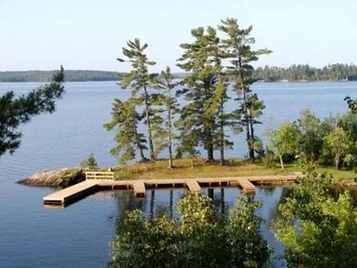 Voyageurs National Park Campsites — Aerial view of the Kabetogama Lake Group campsite with three large docks overlooking a large, scenic lake.