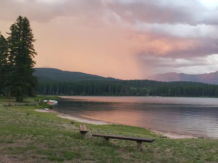 Seeley Lake Campground — View from Seeley Lake swim beach at dusk. A storm rolls in from the East.