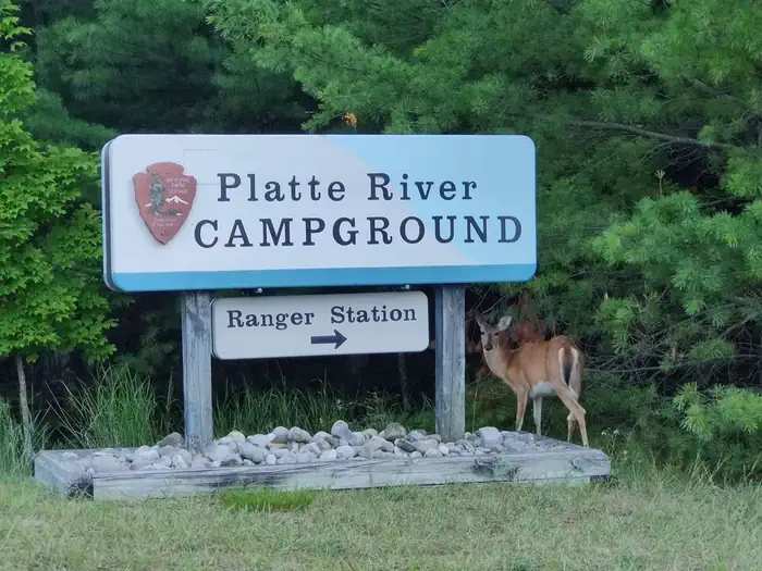 Platte River Campground — A deer stands warily near the Platte River campground entrance sign
