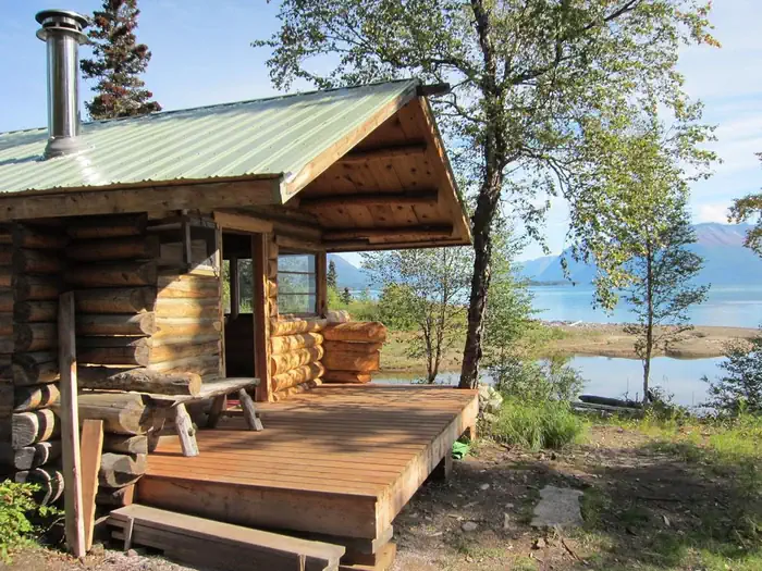 Priest Rock Cabin — An exterior view of Priest Rock Cabin with Lake Clark in the background