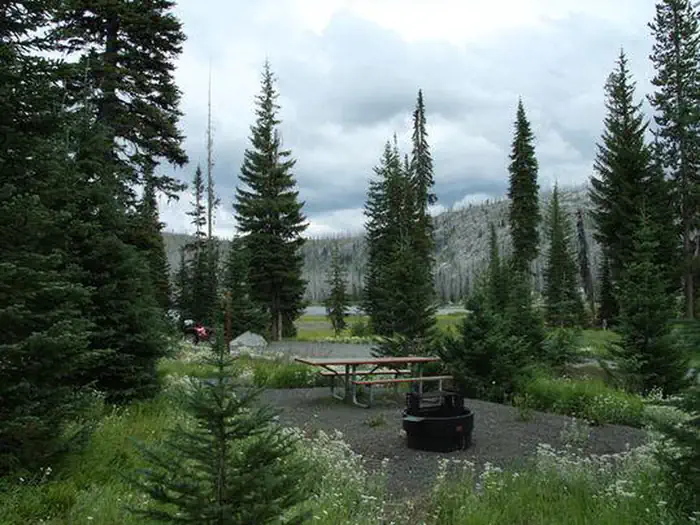 Hazard Lake Campground — Forested campsite with Hazard Lake in the distance.