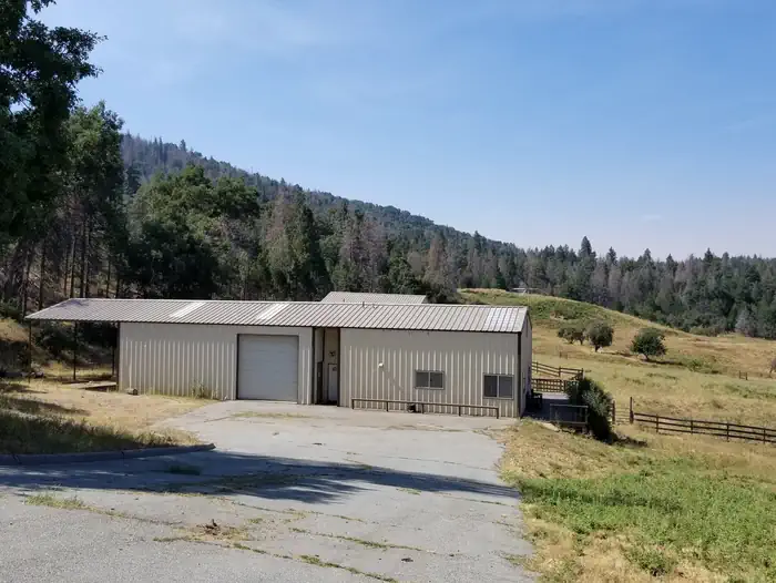 Grouse Valley — Exterior view of the metal workshop and attached caretaker's apartment.