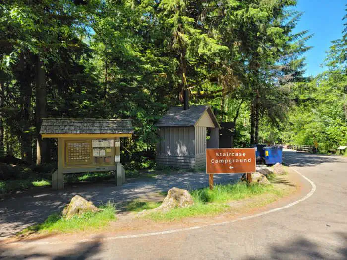 Staircase Campground — The entrance to Staircase Campground with a campground registration board and a pit toilet.