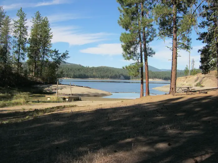 Cloverleaf Campground (wa) — Cloverleaf Campground. Trees and lake in the background.