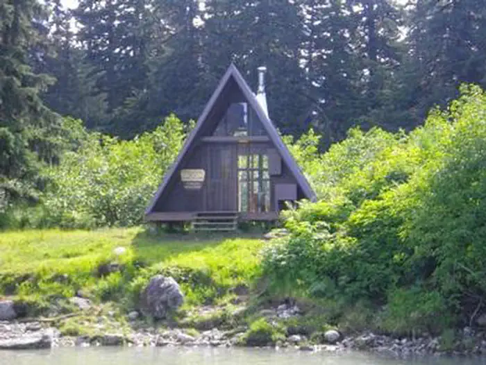 Shakes Slough 2 Cabin — Shakes Slough 2 Cabin exterior of AFrame cabin with greenery surrounding it