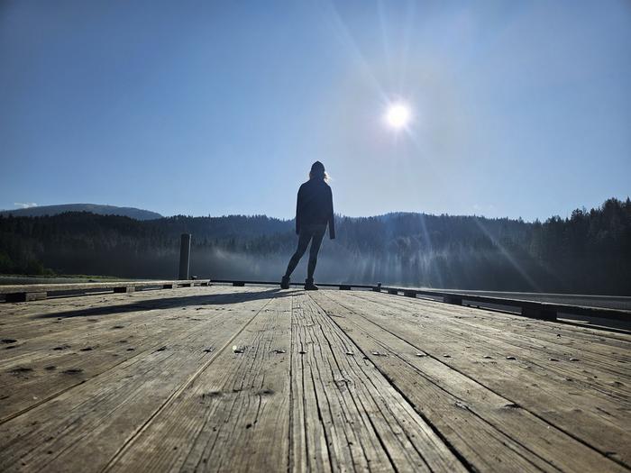 South Skookum Lake Campground — A person stands silhouetted at the end of the dock at South Skookum Lake Campground.