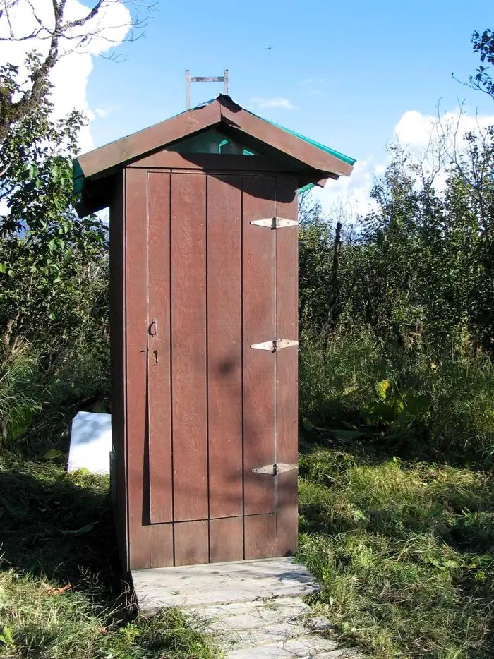 Koknuk Cabin — Outhouse at Koknuk Cabin surrounded by vegetation with green plexiglass as roof