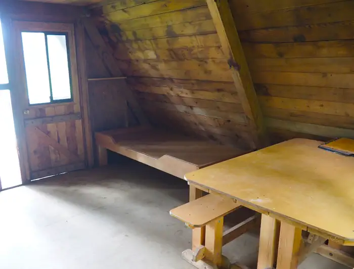 Mount Flemer Cabin — Mount Flemer Cabin interior showing wood table and bed