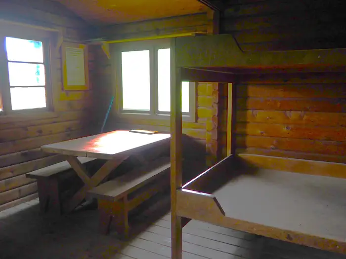 Sergief Island Cabin — Sergief Island Cabin interior showing wood bunkbed and table