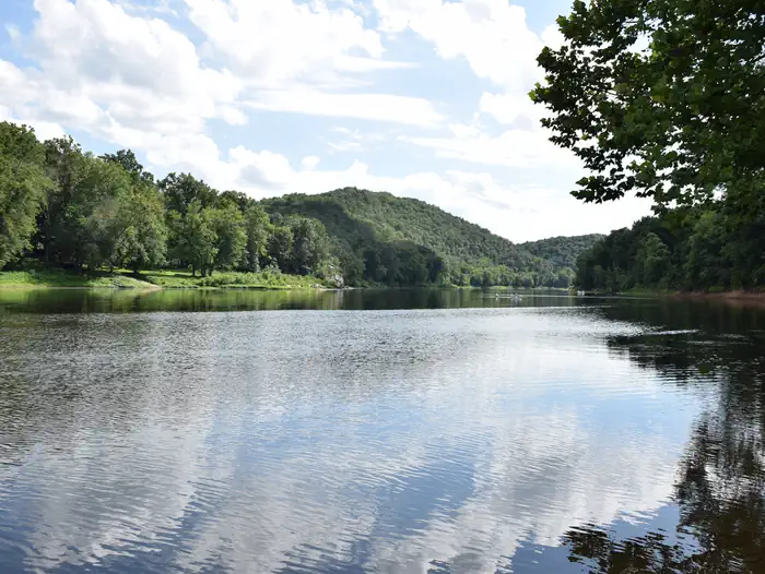 Mccoy's Ferry Campground — The Potomac River reflects a blue sky and fluffy clouds at McCoys Ferry