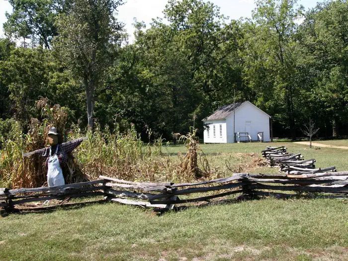 Alley Spring — A historic one room schoolhouse at Alley Spring with garden and scarecrow in the foreground