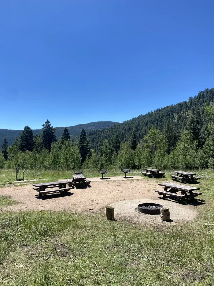 Jacks Creek Horse Camp — Site A with picnic tables, campfire ring, and grills. Trash Cans near vault toilets and private parking.