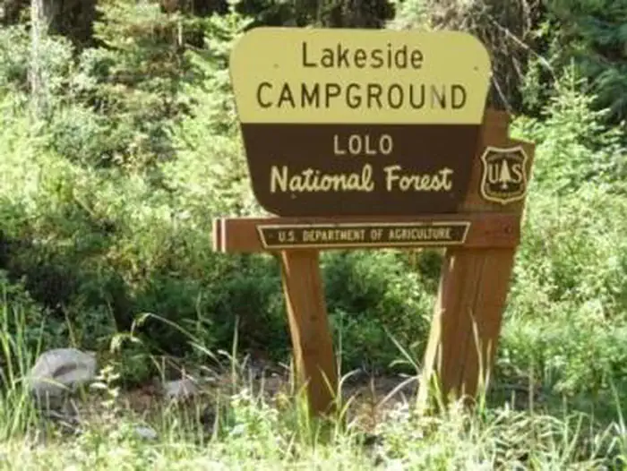 Lakeside - Group Campsite — Lakeside Campground Entrance Sign- it is Cream and Brown in Color with a Forest Service Shield