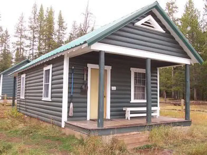 Kelley Guard Station — A wooden cabin with a porch in the woods