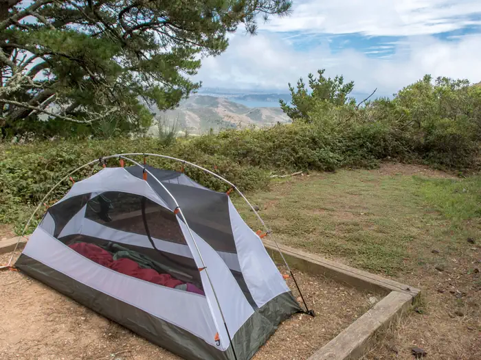 Hawk Camp Campground — A tent in a tent pad at Hawk Campground, with a glimpse of the view in the background.