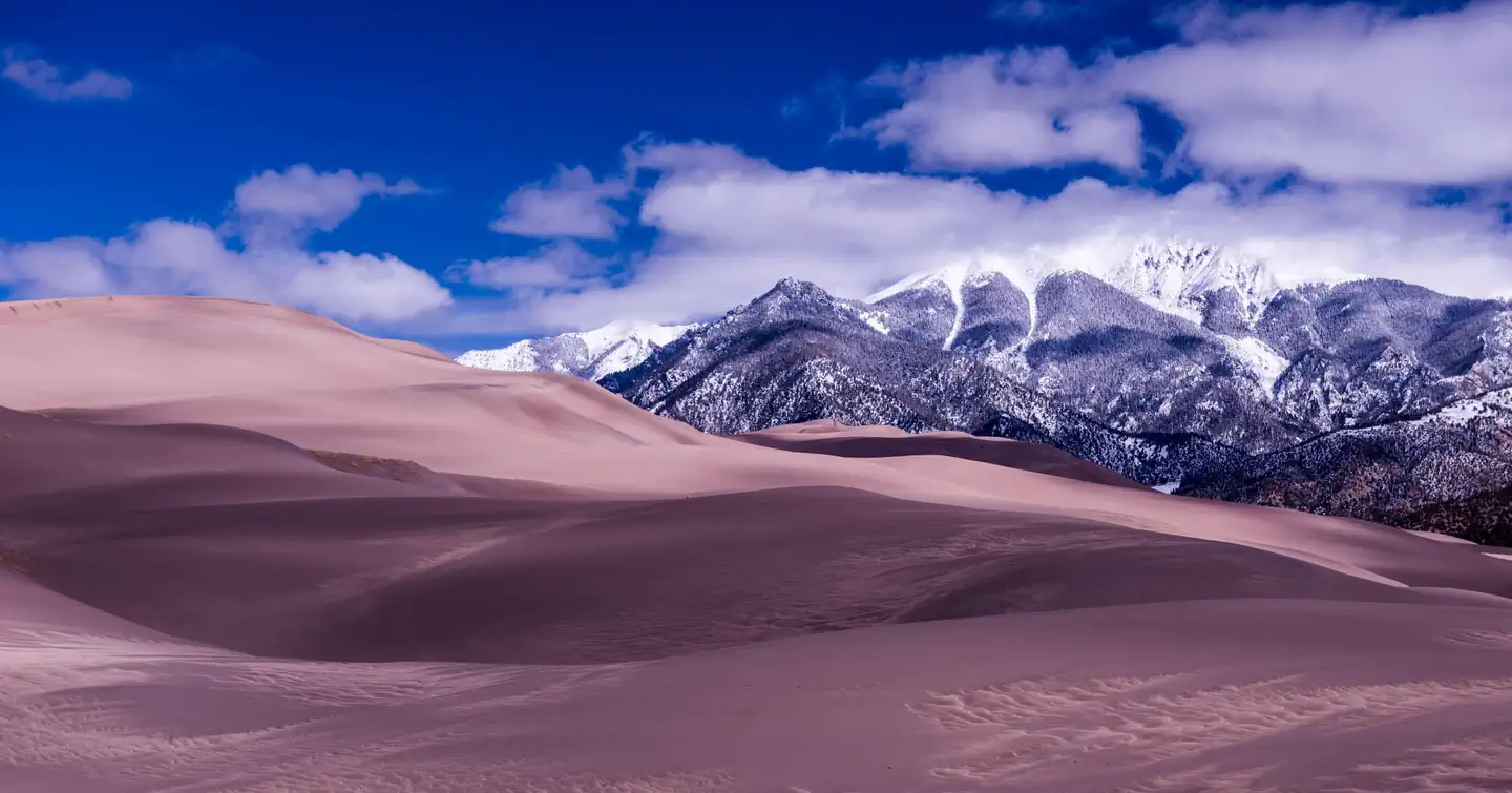 Pinon Flats Campground — Rolling sand dunes with snowy mountains in the background.