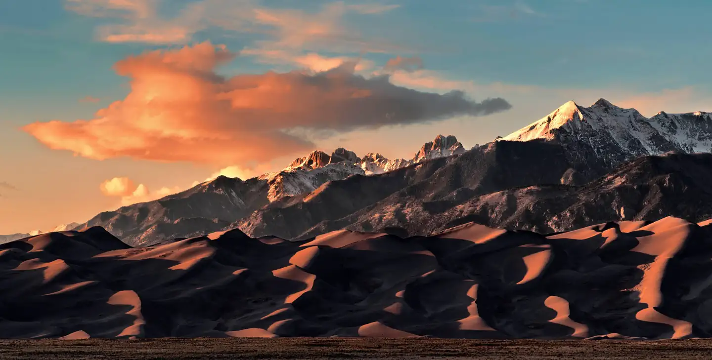 Pinon Flats Campground — Dramatic shadows play on the sand dunes with tall, snow-covered peaks towering.