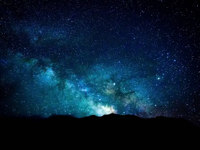 Pinon Flats Campground — Night sky with the Milky Way over dark sand dunes.