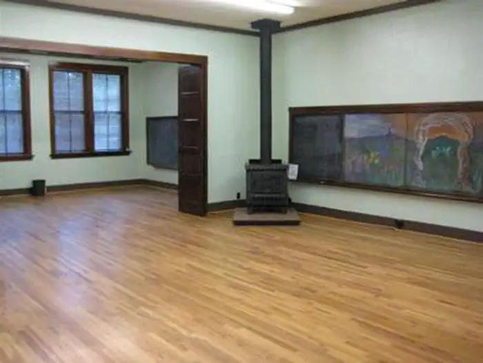 Groom Creek Schoolhouse β GROOM CREEK SCHOOLHOUSE interior fire place, wooden floors and mural on the right wall