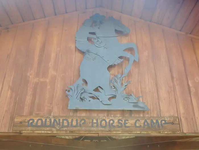 Roundup Group Horse Camp — A metal sculpture depicting a cowboy on a bucking bronco at Roundup Horse Camp