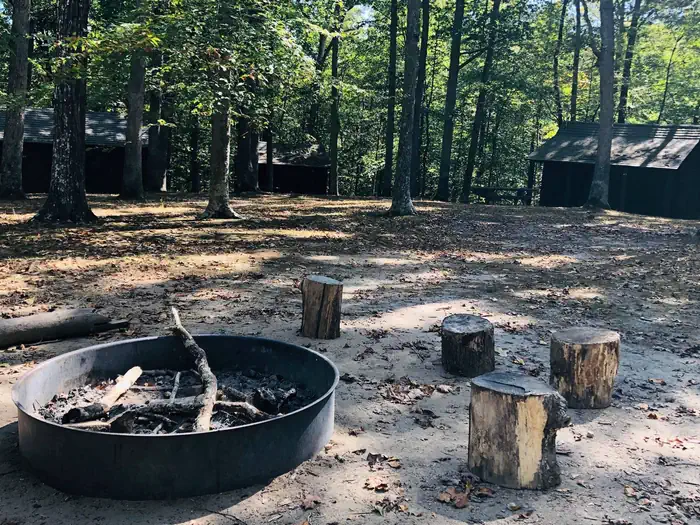 Cabin Camp 3 — Fire circle surrounded by cabins.