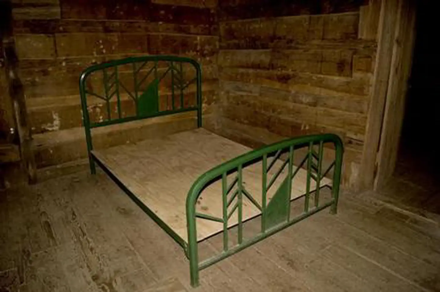 Donley Cabin — Full size metal bed frame inside cabin