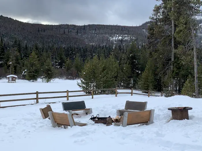 Star Meadows Guard Station — Benches around a campfire in the wintertime.