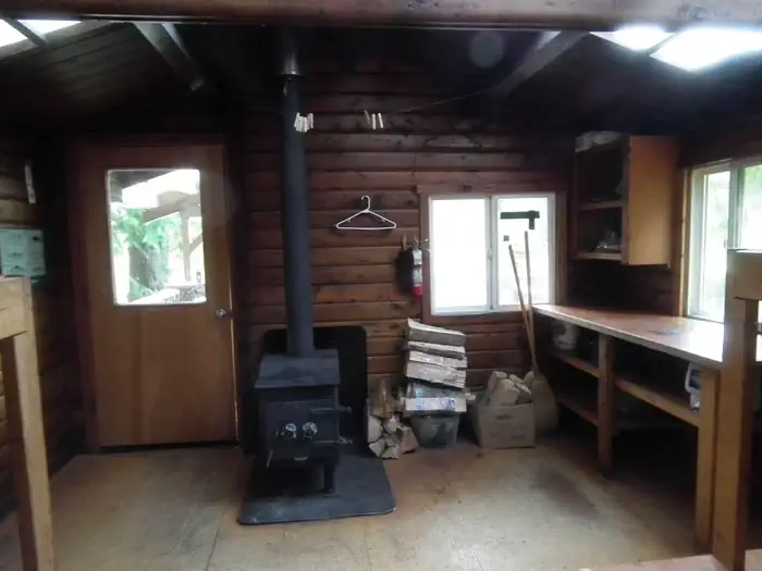 Mcdonald Lake Cabin β Front half of Interior with stove and kitchen area