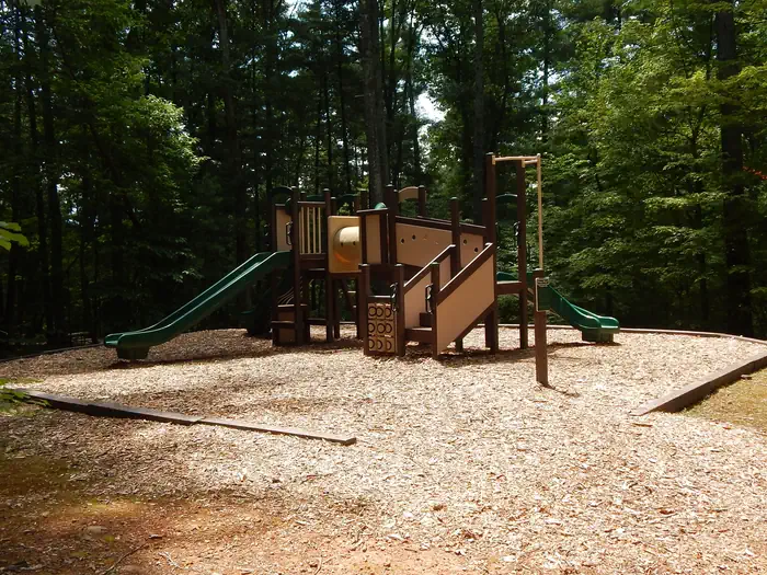 Horseshoe Point — Children's playground surrounded with wood chips and nestled in the forest.