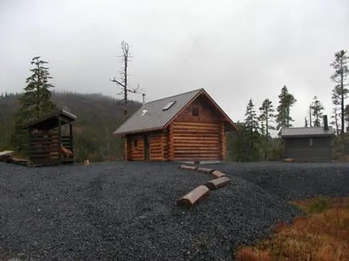 Middle Ridge Cabin — Middle Ridge Cabin on gravel drive with outhouse and woodshed