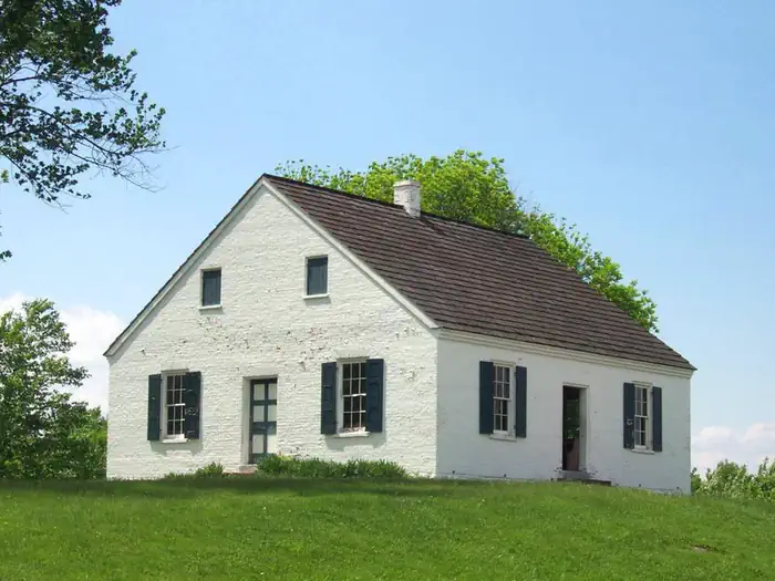 Rohrbach Group Campground — Historic Dunker Church, a white stone building under a blue sky